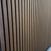 Dark oak slatted wall panel for modern interiors