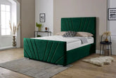 Green bed with a matching headboard in a room with light-colored walls and wooden flooring.