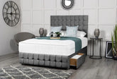 Gray upholstered bed with tufted headboard in a modern bedroom setting.