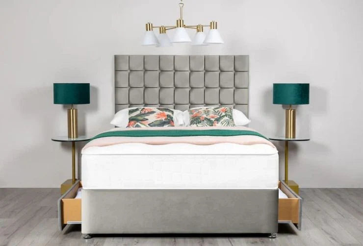 Modern bedroom setup with a bed, lamps, and headboard.
