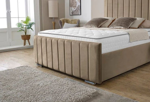 Beige upholstered bed in a room with a window and plant