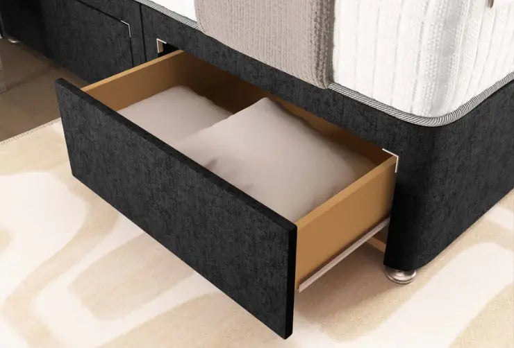 Bed with an open drawer revealing a mattress on a beige carpeted floor.